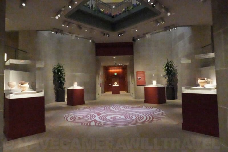 Dark museum interior with pottery on pedestals, ISO 64000 test image