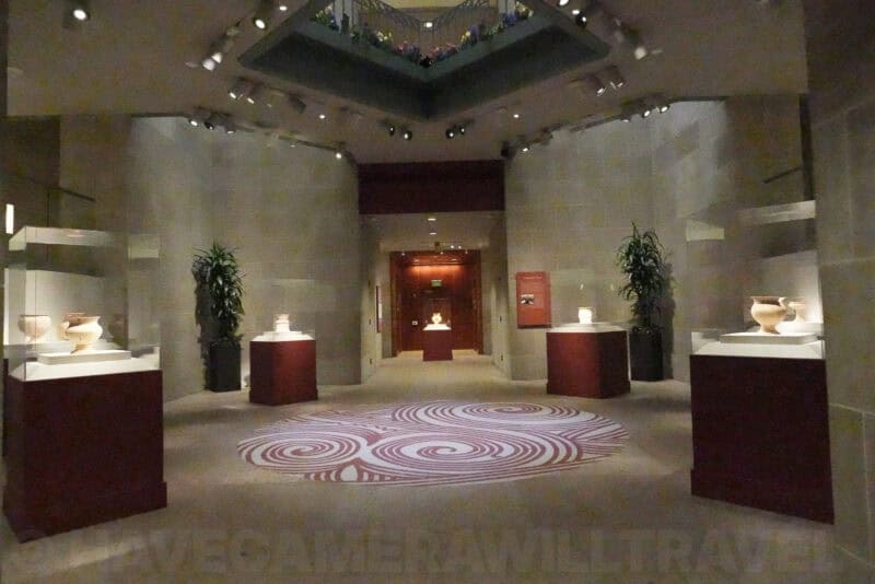 Grainy museum gallery photo with ceramic displays at ISO 80000