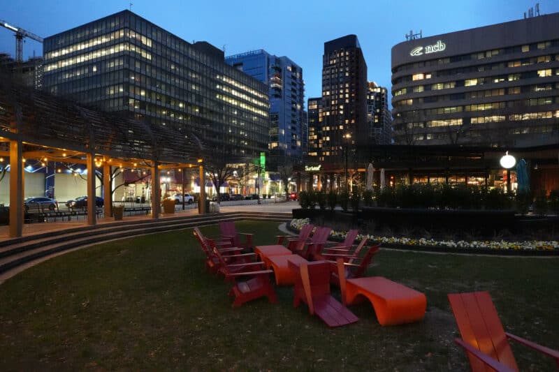 Dusk cityscape with red lounge chairs and building lights, ISO 12800 grain test shot