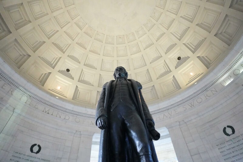 Bronze statue of Thomas Jefferson viewed from below inside the domed Jefferson Memorial rotunda