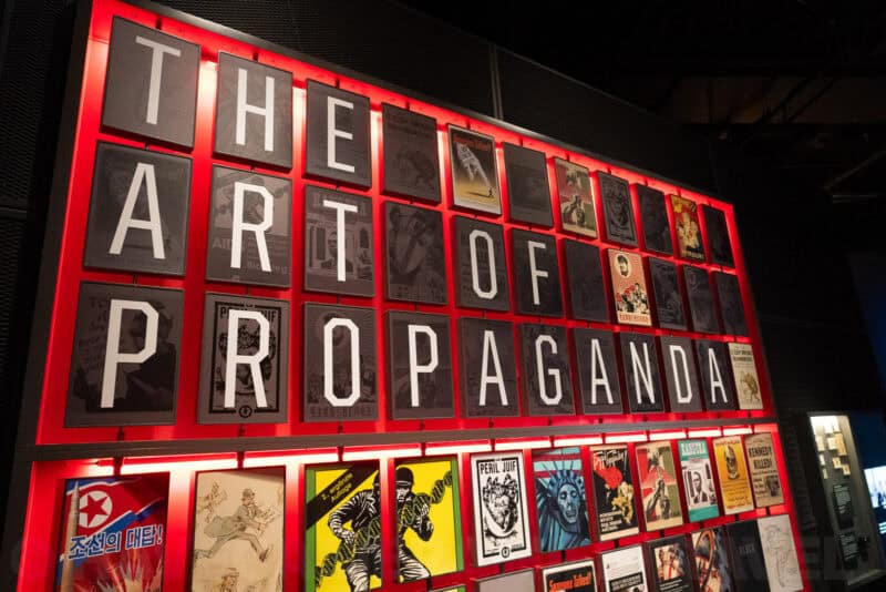 Museum exhibit wall titled 'The Art of Propaganda' displaying historical posters