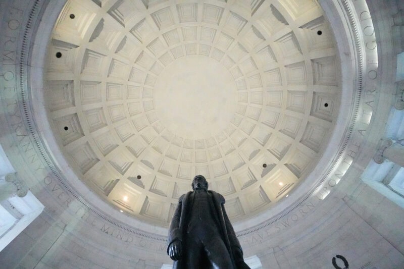 Bronze Jefferson statue viewed from below inside the illuminated dome of the Jefferson Memorial