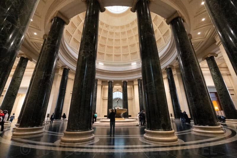 Domed rotunda with tall dark marble columns inside the National Gallery of Art