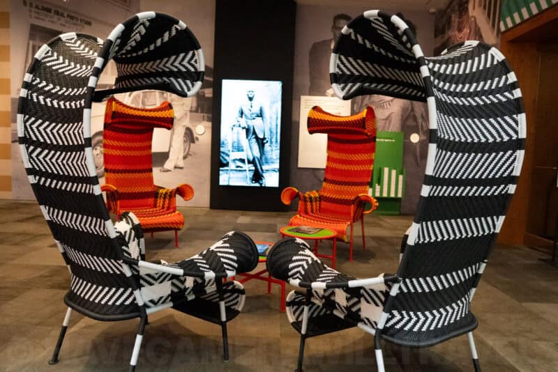 Colorful woven zebra-striped lounge chairs in a museum exhibit space