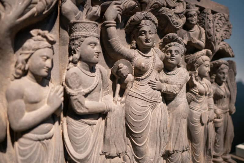 Close-up of carved stone figures in an ancient relief sculpture
