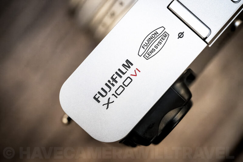 Close-up of the Fujifilm X100VI top plate showing the engraved model name and Fujinon lens system logo