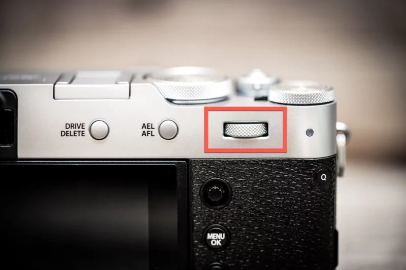 Fujifilm X100VI rear command dial highlighted in a red box beside the AEL/AFL button