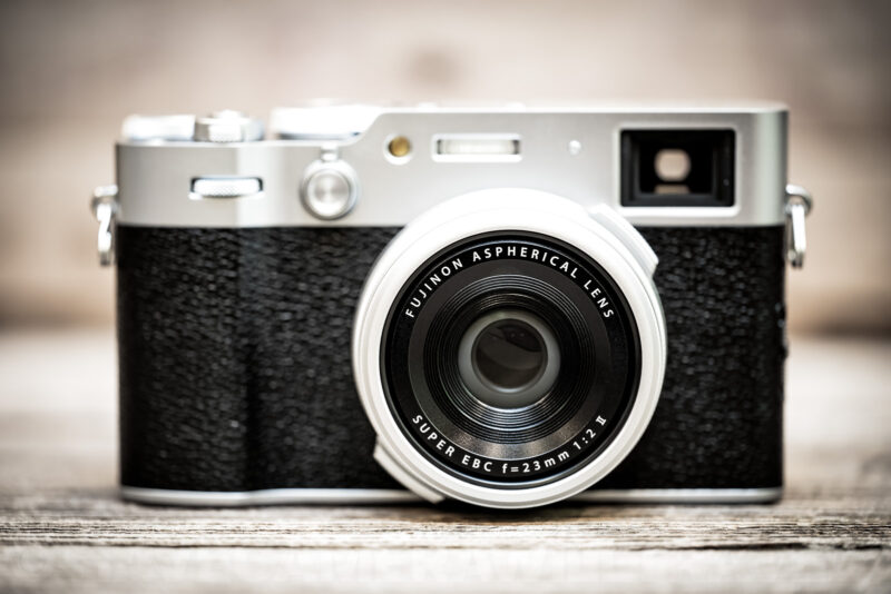 Fujifilm X100VI front view showing its silver top plate, viewfinder window, and Fujinon aspherical lens