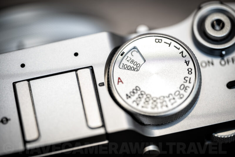 Close-up of the Fujifilm X100VI's top ISO dial showing settings up to 12800 and the C custom position