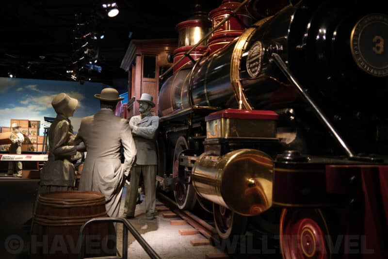 Life-size figures beside a vintage steam locomotive in a museum diorama at ISO 160 retaining fine detail