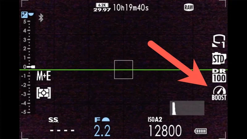 Fujifilm X100VI viewfinder display with an arrow pointing to the Boost mode icon in the status column