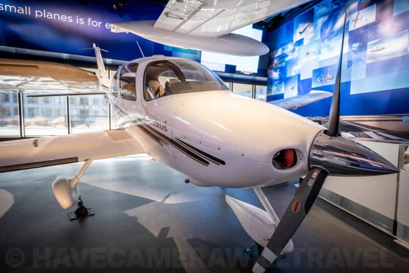 Small white Cirrus aircraft on display inside the National Air and Space Museum