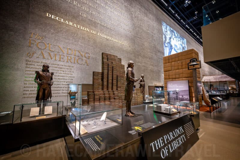 Founding of America exhibit at the African American history museum with bronze statues and brick pillars