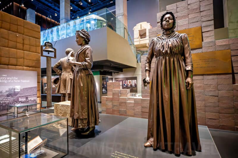 Bronze statues of enslaved and freed figures in the National Museum of African American History exhibit