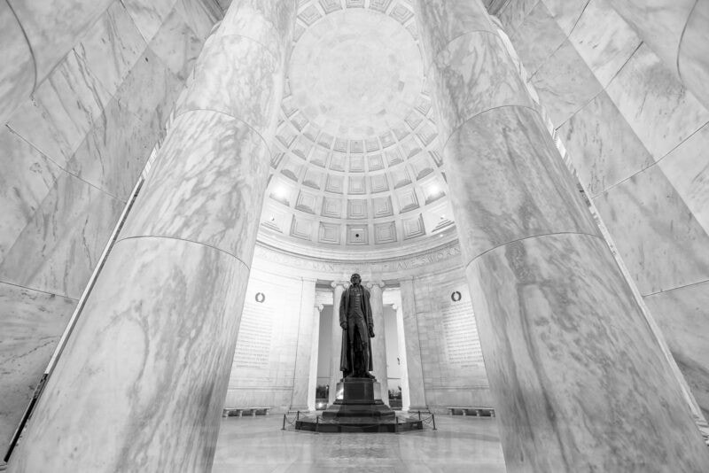 Marble columns framing the statue of Thomas Jefferson inside the Jefferson Memorial rotunda