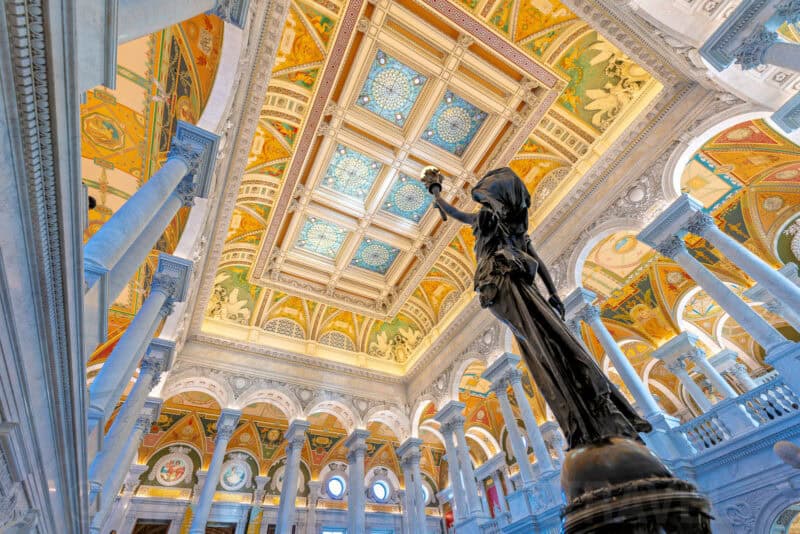 Ornate gilded ceiling and bronze statue in the Great Hall of the Library of Congress