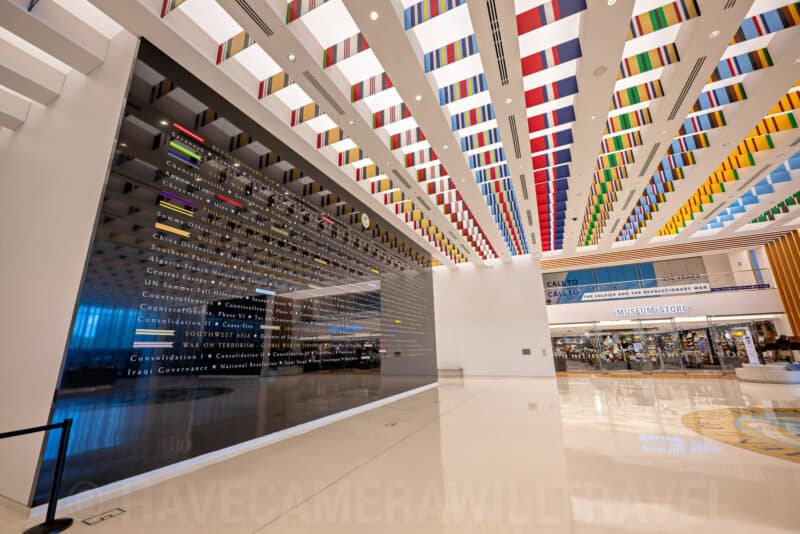 Colorful ribbon-like ceiling installation and museum store in a modern building lobby