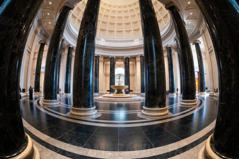 Dark marble columns encircling a fountain beneath a coffered dome at the National Gallery of Art