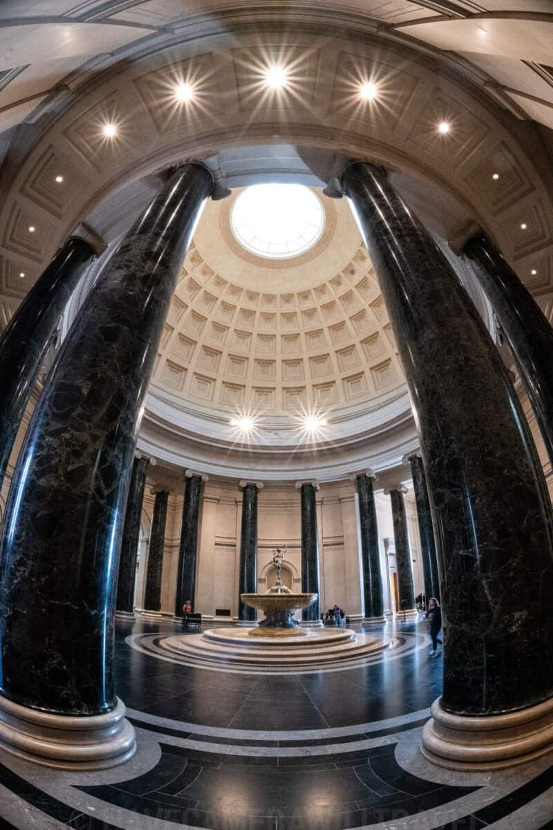 Fisheye view of the National Gallery of Art rotunda fountain with star-burst light effects from the ceiling lamps