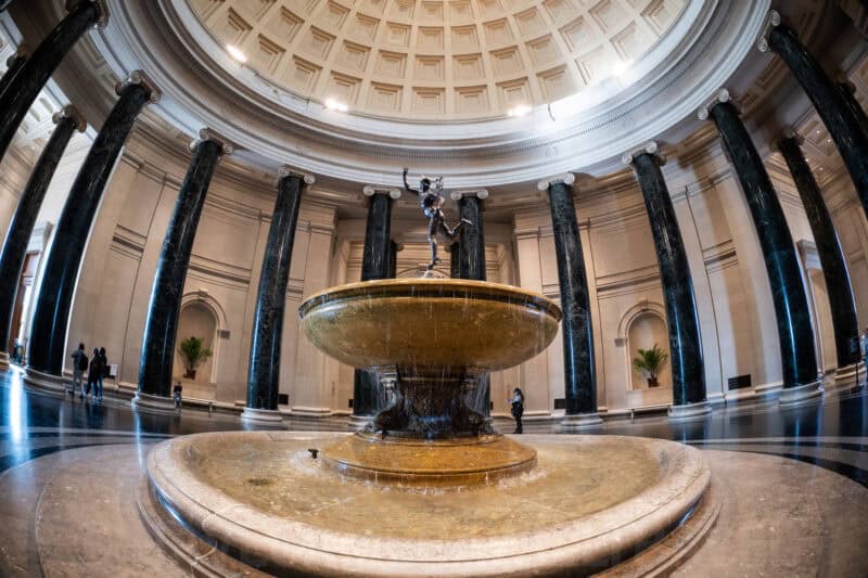 Bronze fountain statue rising from a marble basin beneath the domed rotunda at the National Gallery of Art