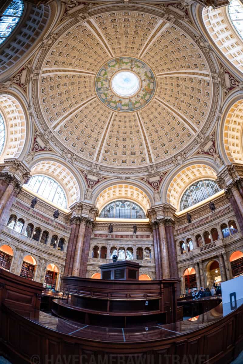Upward fisheye view of the domed ceiling and curved wooden desk in the Library of Congress reading room