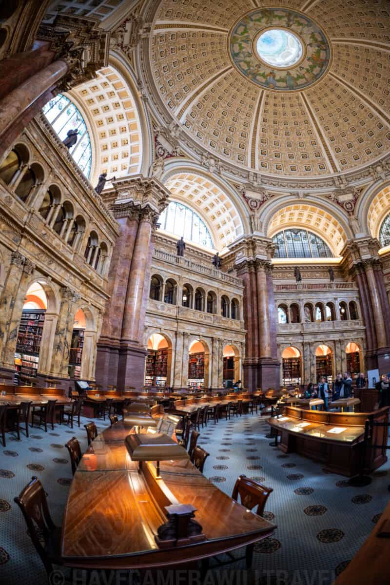 Fisheye view of the domed reading room ceiling and long wooden tables in the Library of Congress