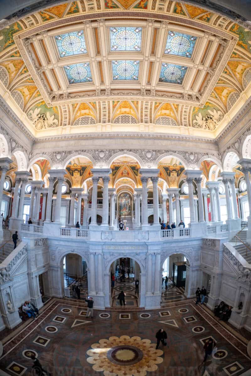 Fisheye view down onto the patterned marble floor and grand staircases of the Library of Congress Great Hall
