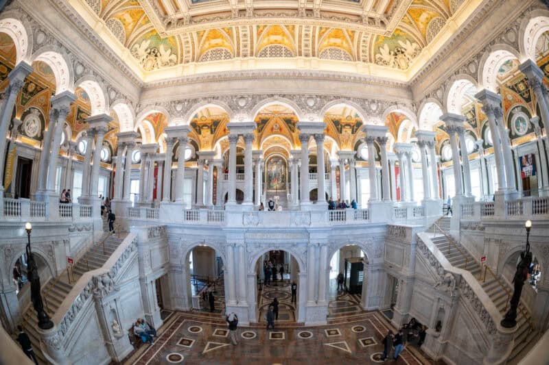 Fisheye view of the Library of Congress Great Hall with its grand staircases and painted vaulted ceiling