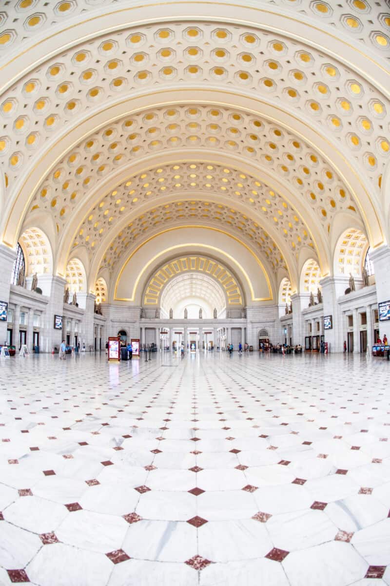 Fisheye view of Union Station's ornate coffered barrel-vaulted ceiling above a checkered marble floor