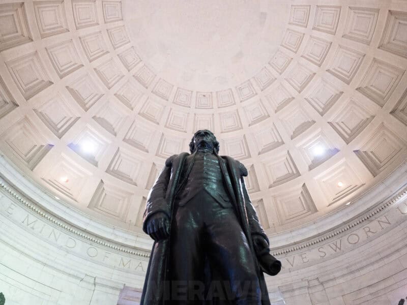 Bronze statue of Thomas Jefferson viewed from below inside the domed memorial rotunda