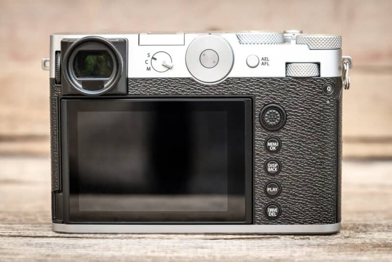 Rear view of the Fujifilm X100VI camera showing its viewfinder, LCD screen, and control dials