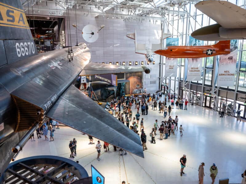 Aerial view of Milestones of Flight Hall with historic aircraft suspended above museum crowds