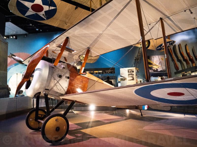 Vintage biplane with red white and blue roundel on display inside an aviation museum hangar