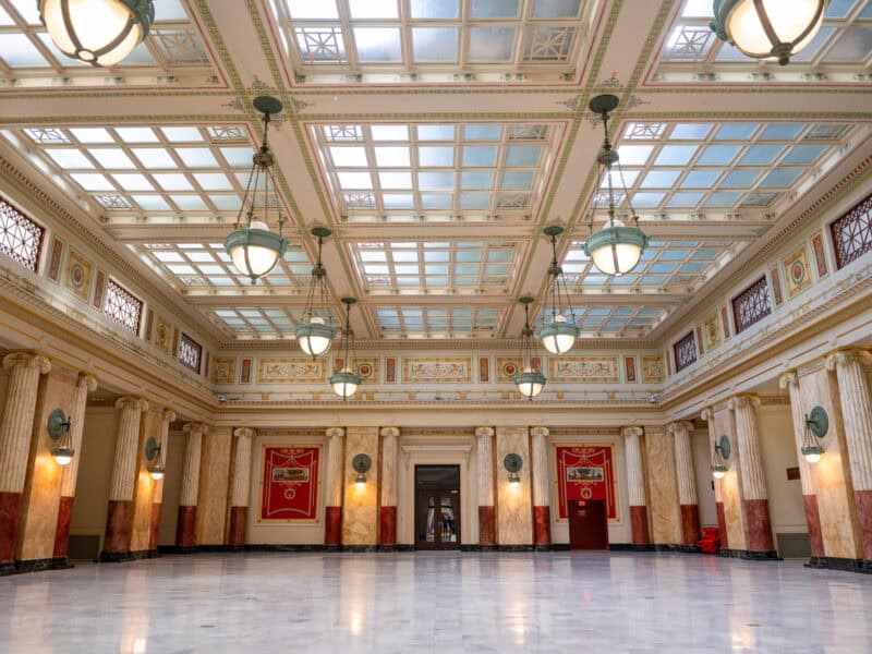 Grand marble ballroom with skylight ceiling and hanging lanterns inside Union Station