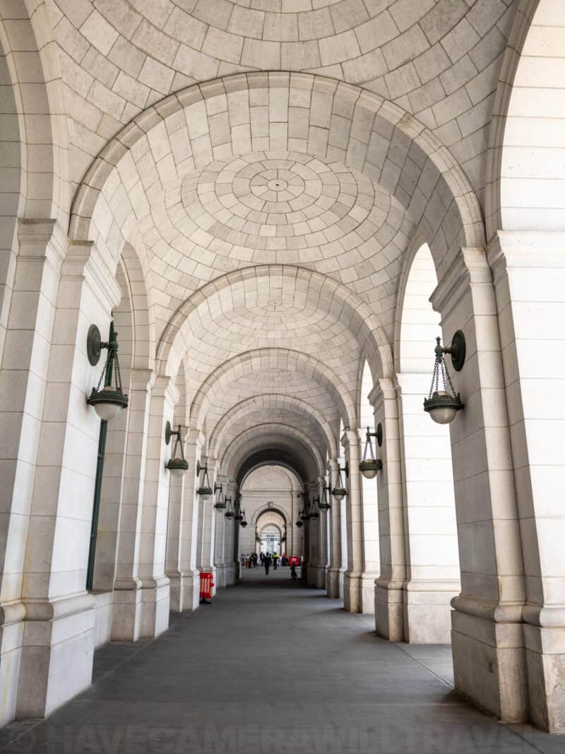Vaulted stone archway corridor lined with lanterns at Union Station in Washington DC