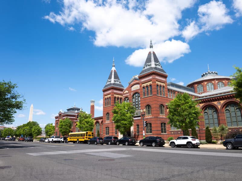 Smithsonian Arts and Industries Building's red brick towers with the Washington Monument beyond