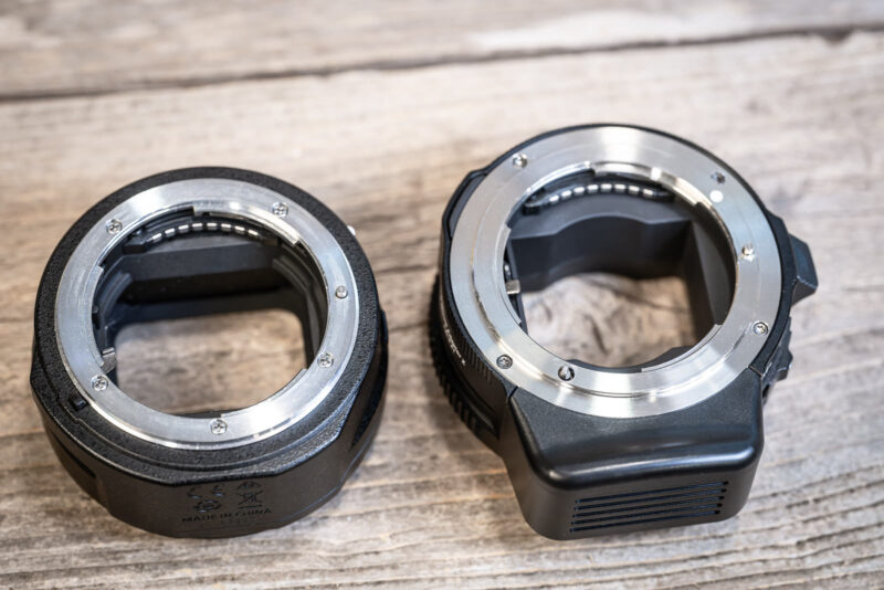 Nikon FTZ II and MonsterAdapter LA-FZ1 lying side by side, showing mount openings and the LA-FZ1's bulkier motor housing