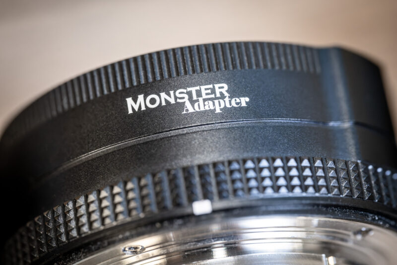 Macro view of the MonsterAdapter logo on the LA-FZ1's black barrel above its knurled focus-drive ring